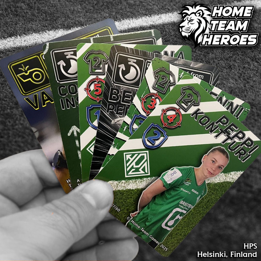 Hand holding HPS Helsinki Team Deck cards with Peppi Kontturi and teammates in green kits on pitch background.