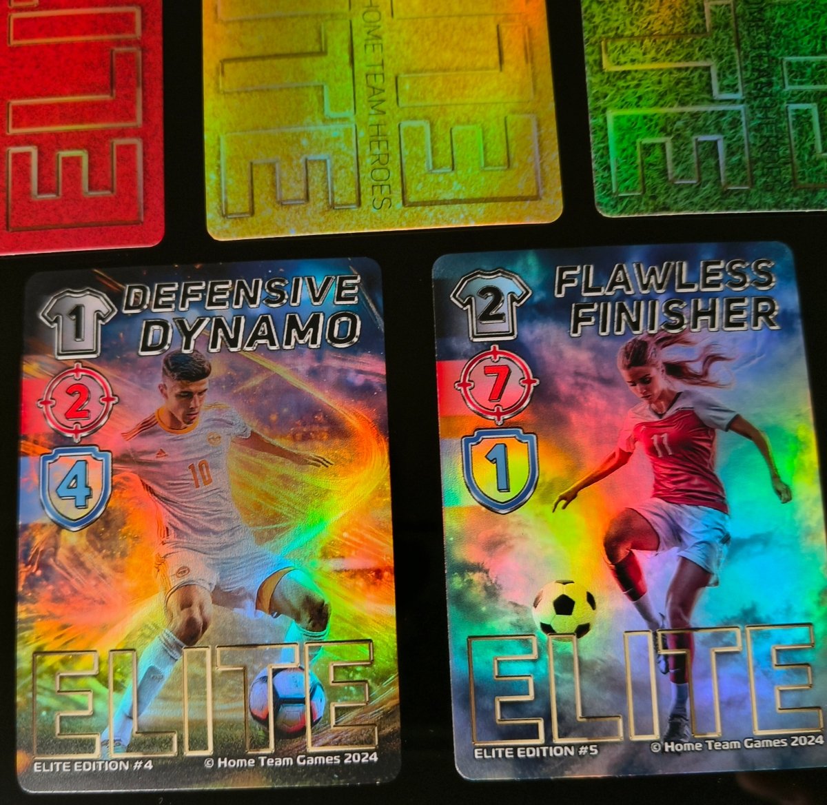 Close-up of Elite Edition cards Flawless Finisher and Defensive Dynamo with vibrant foil effects from Home Team Heroes.