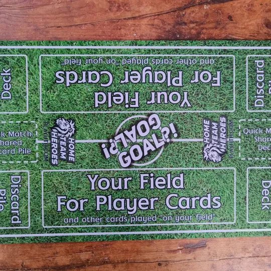 Top view of Home Team Heroes football playmat with grass pitch design, player zones, and a goal marker for tabletop play.