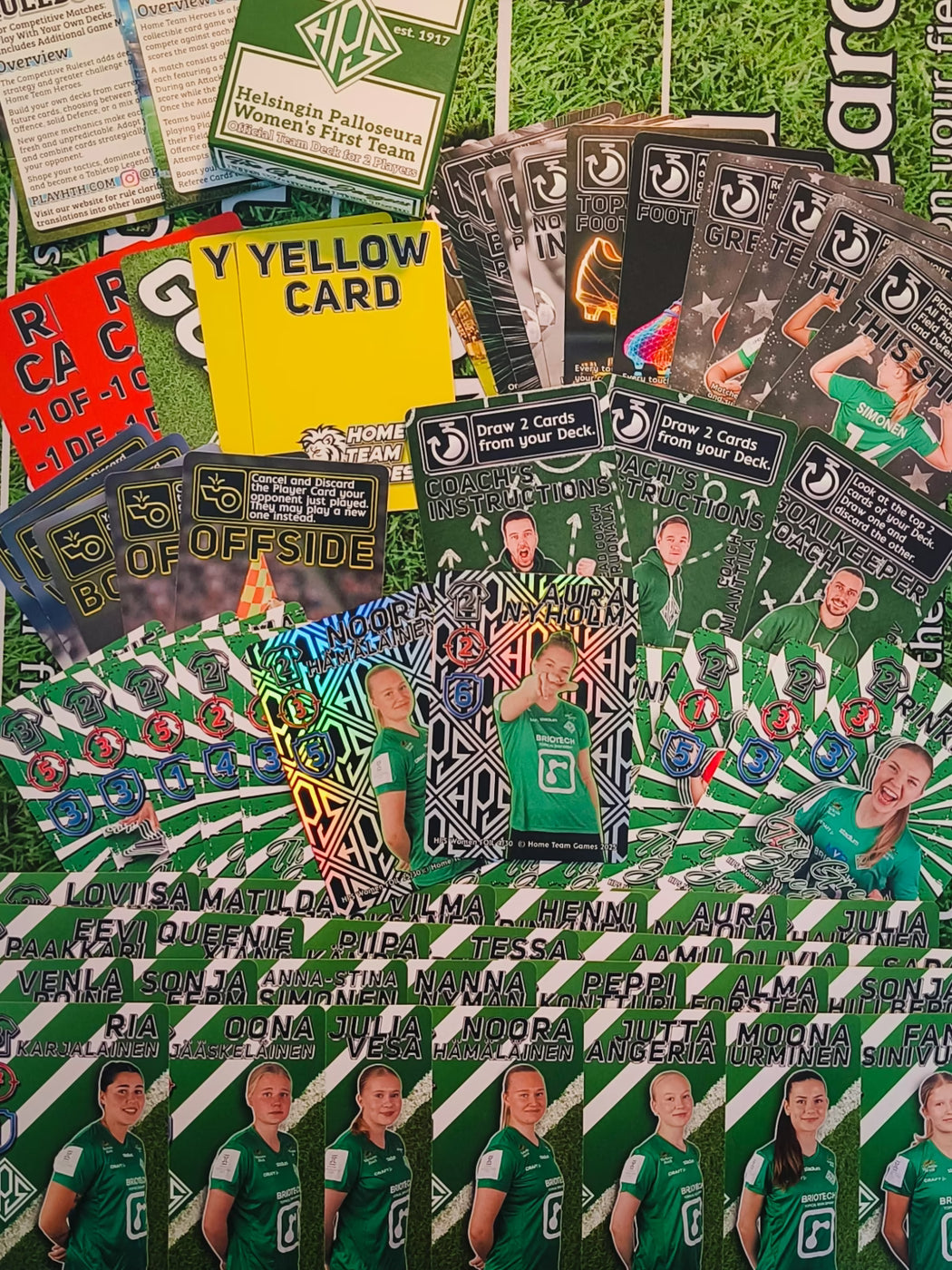 HPS Helsinki Team Deck contents showing player cards, event cards, referee cards, rulebooks and premium foil cards spread on table.
