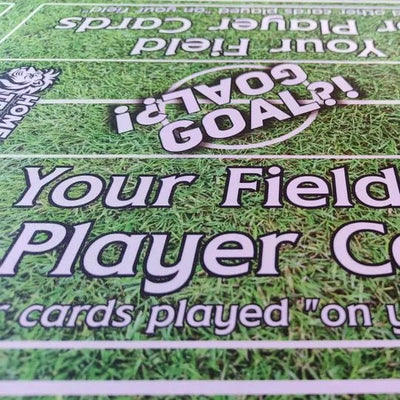 Close-up of grass pitch playmat showing the zone and card fields, details for immersive football gameplay.